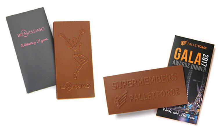 Chocolate bars with embossed logos and designs from Bravissimo and Palletforce, displayed next to branded packaging for a gala event.