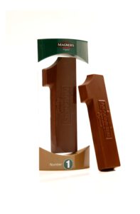 296w8255_v2_1 The product, Chocolate Number One, is a chocolate bar shaped like the number one and packaged in a green and brown box labeled Magners.