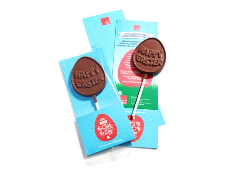 Two chocolate lollipops with "Happy Easter" text, displayed on blue packaging with Easter-themed designs.