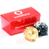 A red Vodafone box displays the message "Make the most of now" next to two chocolates: one in gold foil and another coated with dark chocolate and white sprinkles, from the Logo Chocolate Boxes collection.
