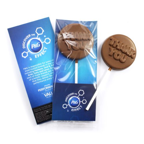 The Thank You Lollipop, wrapped in plastic with "THANK YOU" text, is placed beside a blue "Discover the P&G Effect" card detailing product information.