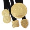 img_0424_-_m3_0724_1 Four gold foil-wrapped chocolate medals on black ribbons, irregularly shaped with embossed designs and text.