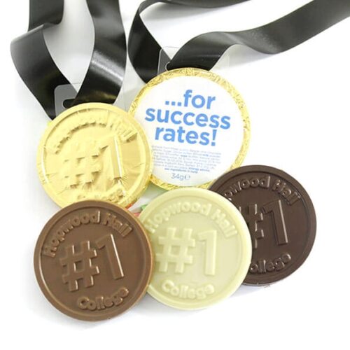img_0631_-_m2_0724.2 Five Bespoke Chocolate Medals with "#1 Hopwood Hall College" inscription, available in gold, silver, and bronze colors, each featuring a black ribbon.