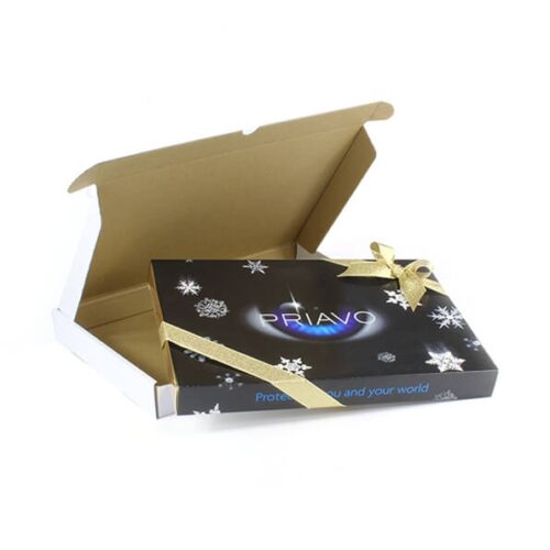 Open cardboard box with a closed, ribbon-wrapped gift box inside. The black gift box is adorned with snowflake designs and features the "PRIAVO" logo. Product: Customised Christmas 48 Chocolate Box.