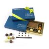 img_4475_-_m2_1024 An open blue box with "O'Reilly Stewart Solicitors" branding and a green ribbon, containing assorted chocolates, including a large rectangular one, is the Truffle with Chocolate Business Card Gift Box.
