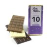 A milk, white, and dark chocolate bar are stacked beside a purple-wrapped Medium Branded Chocolate Bar celebrating "10 years" by Flint Studios.