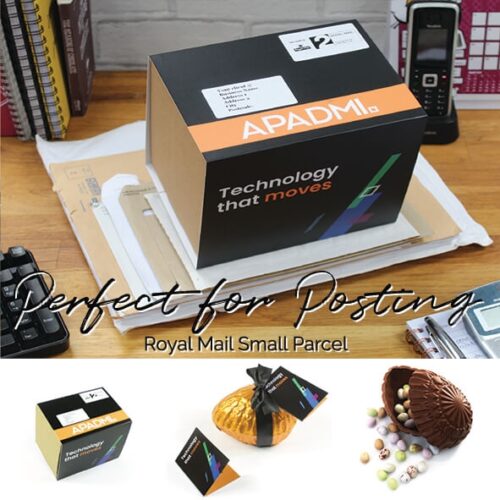A black box displaying "APADMI" branding lies on a desk amid mail items. Below, the box is paired with a small package and a chocolate egg filled with candy, from the Easter Egg Fulfilment Service.