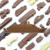 The Chocolate Ship product includes a variety of chocolate shapes featuring vehicles like a prominent ship, motorcycle, and cars, all set against a white background.