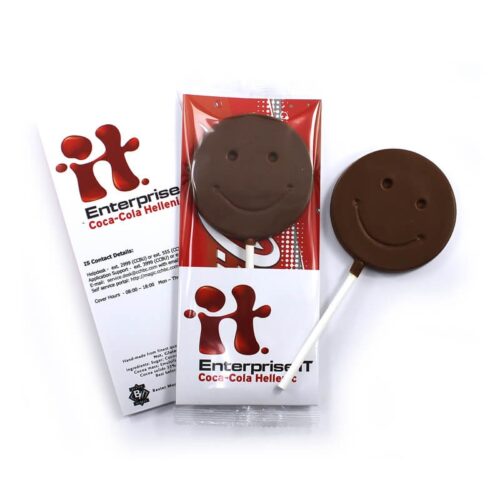 Two Smiley Face Lollipops, one wrapped with Coca-Cola Hellenic branding, accompanied by a contact details card, displayed on a white background.