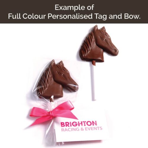 tag_and_bow_square_8 Two Jolly Roger Pirate Flag Lollipops, one adorned with a pink bow and personalized tag, and another unwrapped.