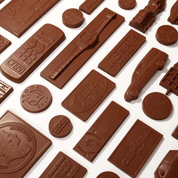 a selection of milk chocolate bespoke shapes set on a white background.